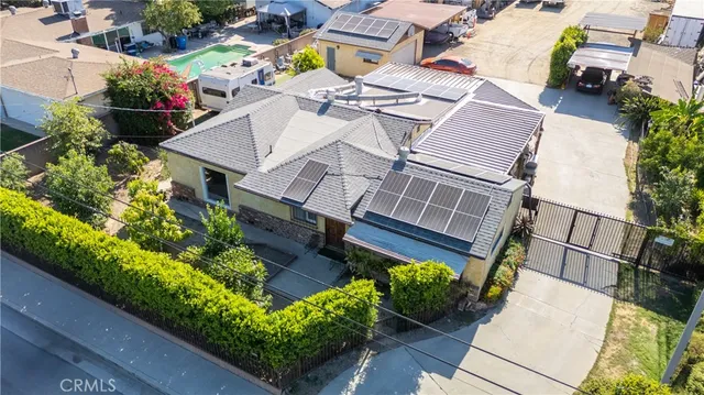 an aerial view of a house with a yard