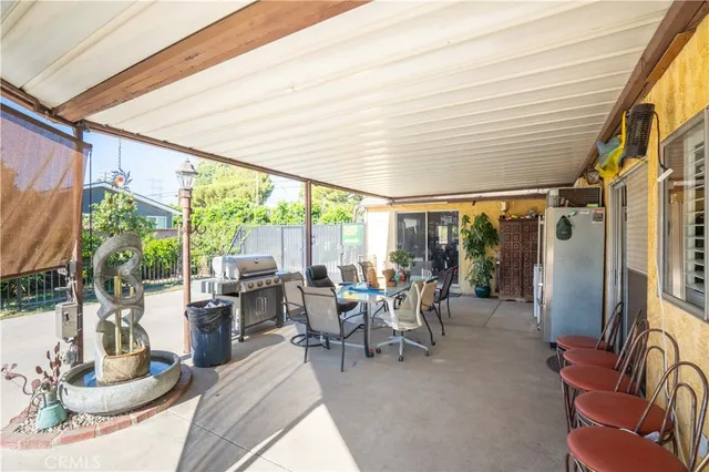 a dining room with furniture and large windows