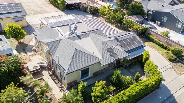 an aerial view of a house with a yard