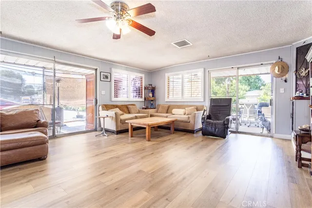 a living room with furniture and a flat screen tv with wooden floor