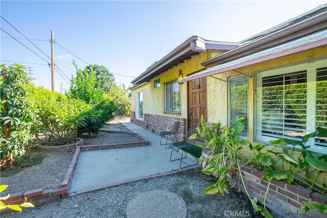 a view of a house with potted plants
