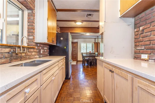 a view of a kitchen with a large window