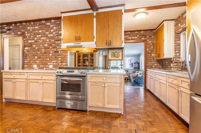 a kitchen with stainless steel appliances a stove sink and cabinets