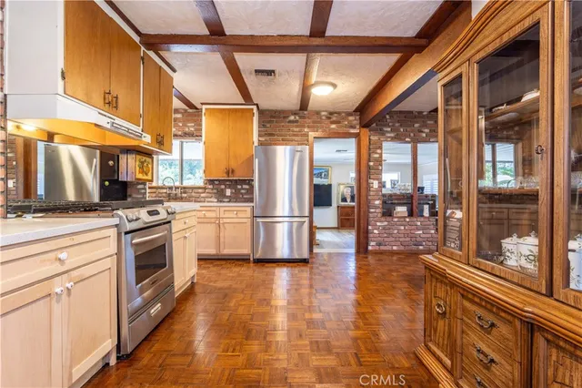 a kitchen with stainless steel appliances granite countertop a stove a sink and a refrigerator