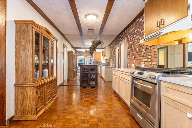 a kitchen with granite countertop a stove and cabinets