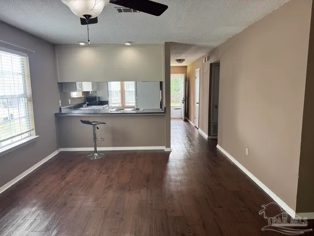 a view of an empty room and wooden floor