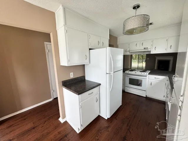 a kitchen with stainless steel appliances a stove a microwave and a refrigerator