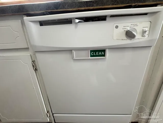 a white refrigerator freezer and a stove sitting inside of a kitchen