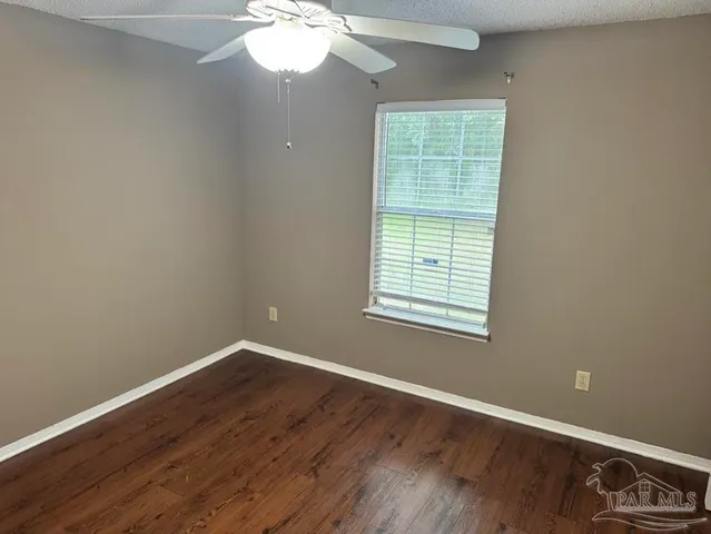 an empty room with wooden floor and closet