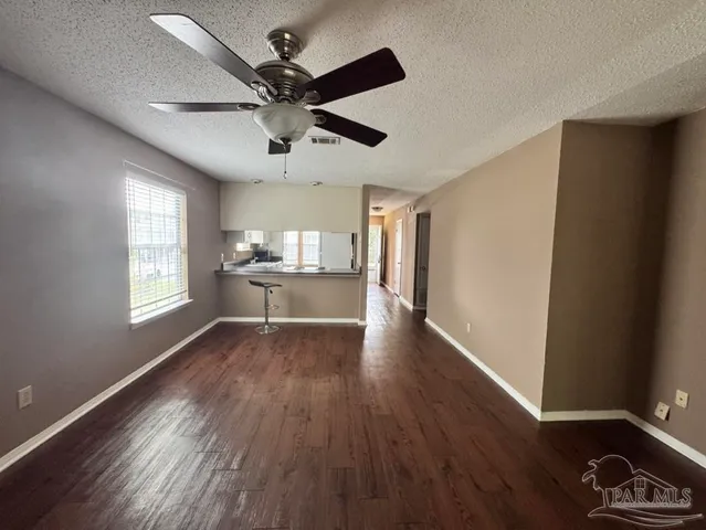 a view of a kitchen with a sink and wooden floor