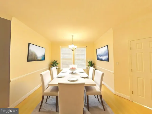 a dining room with furniture and a window