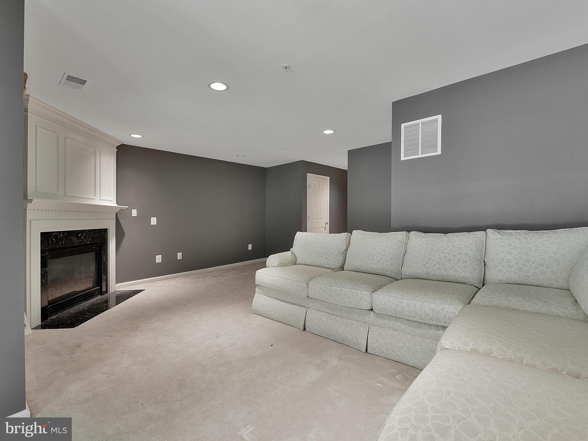 13907 Lullaby Road Germantown, MD 20874 - Photo 35 of 41 Lover level family rec room with gas fireplace