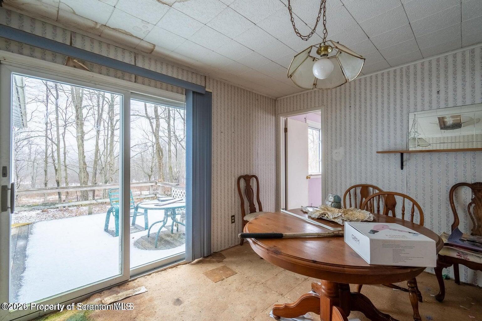 1777 Lamb Road Thompson, PA 18465 - Photo 14 of 31 a view of a dining room with furniture window and outside view