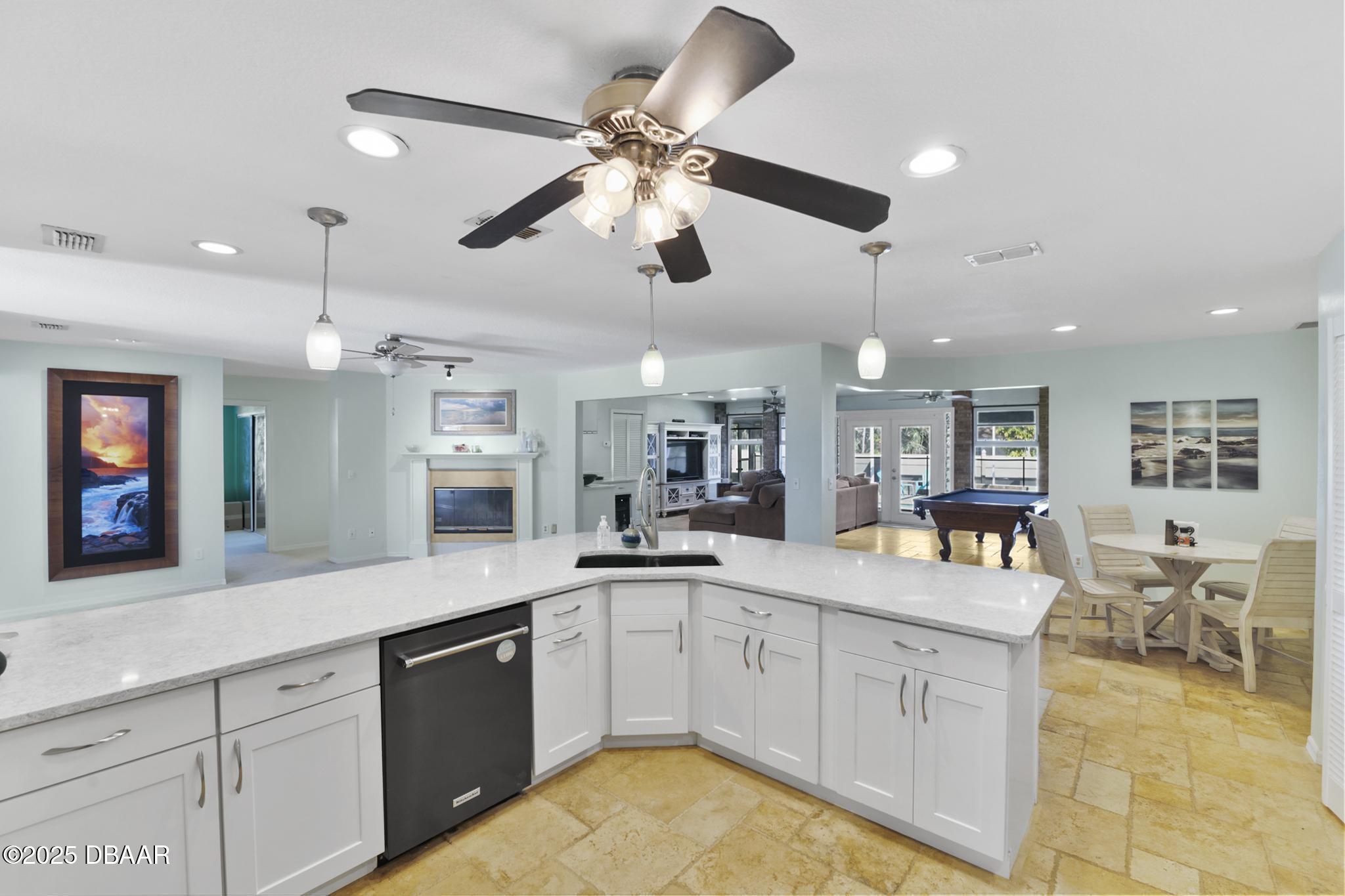 13 Fernery Trail Ormond Beach, FL 32174 - Photo 13 of 57 a large white kitchen with a large island oven a sink and dishwasher