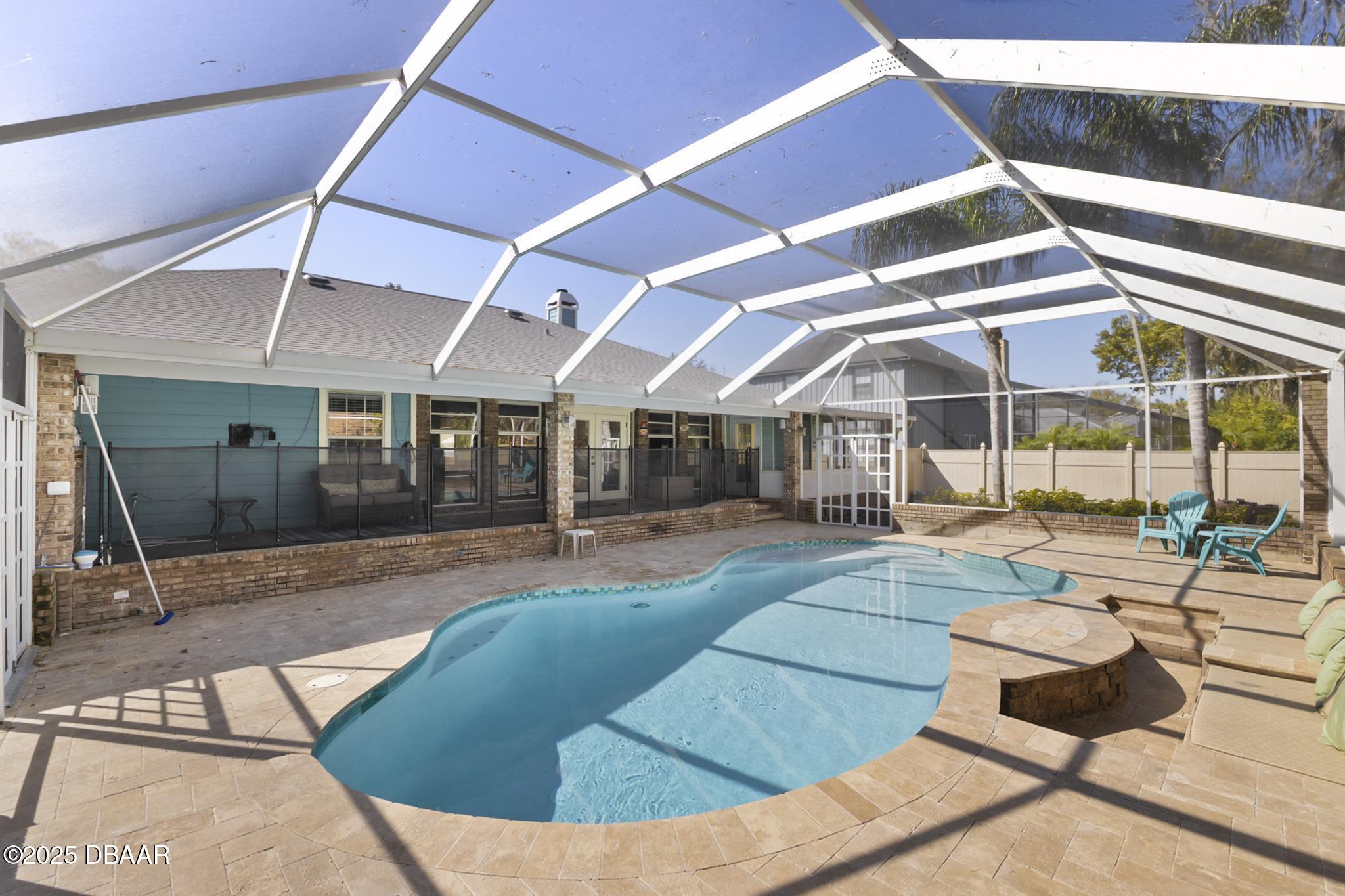 13 Fernery Trail Ormond Beach, FL 32174 - Photo 2 of 57 a view of a patio with table and chairs with wooden floor