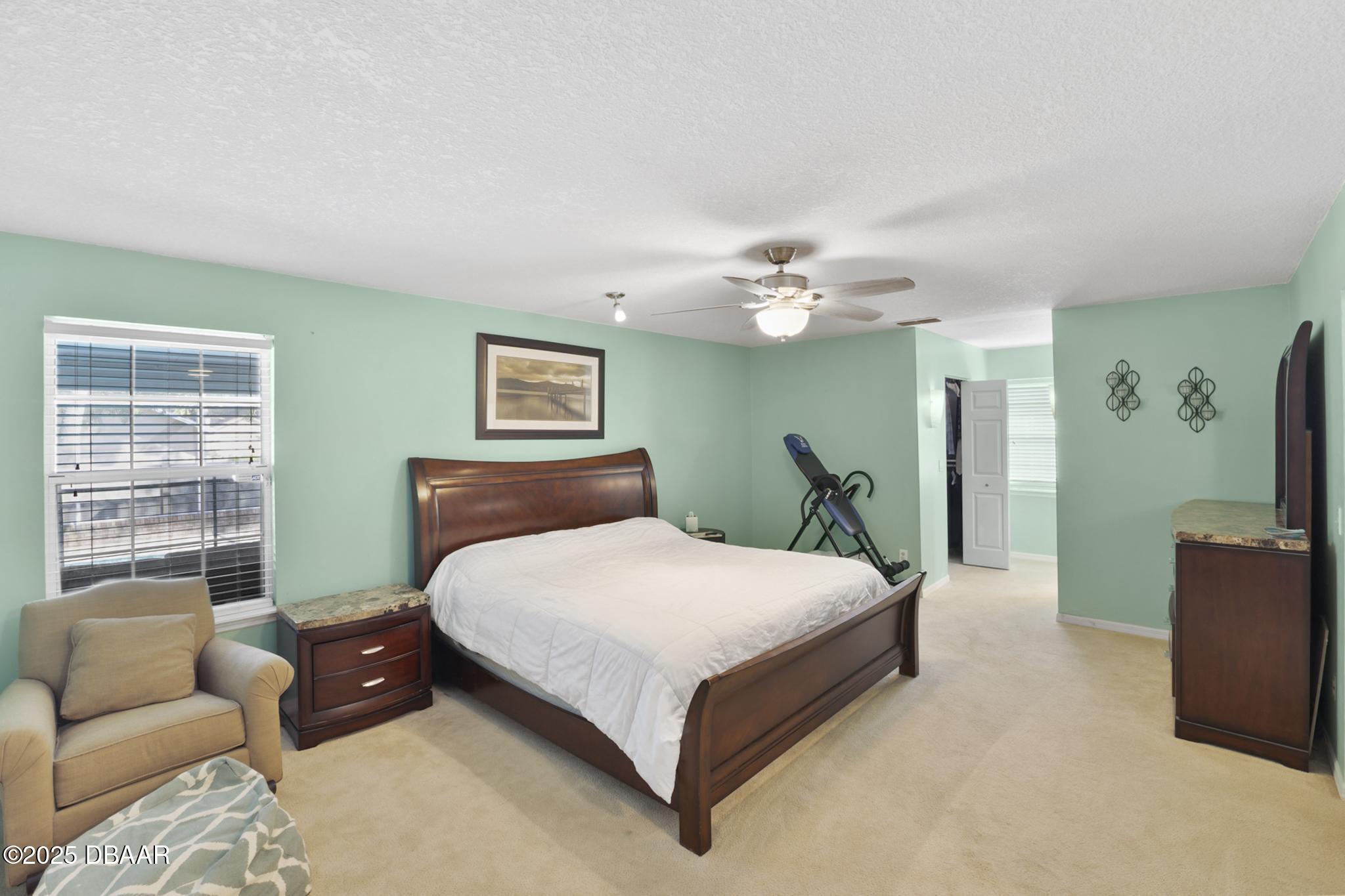 13 Fernery Trail Ormond Beach, FL 32174 - Photo 26 of 57 a bedroom with a large bed and a couch