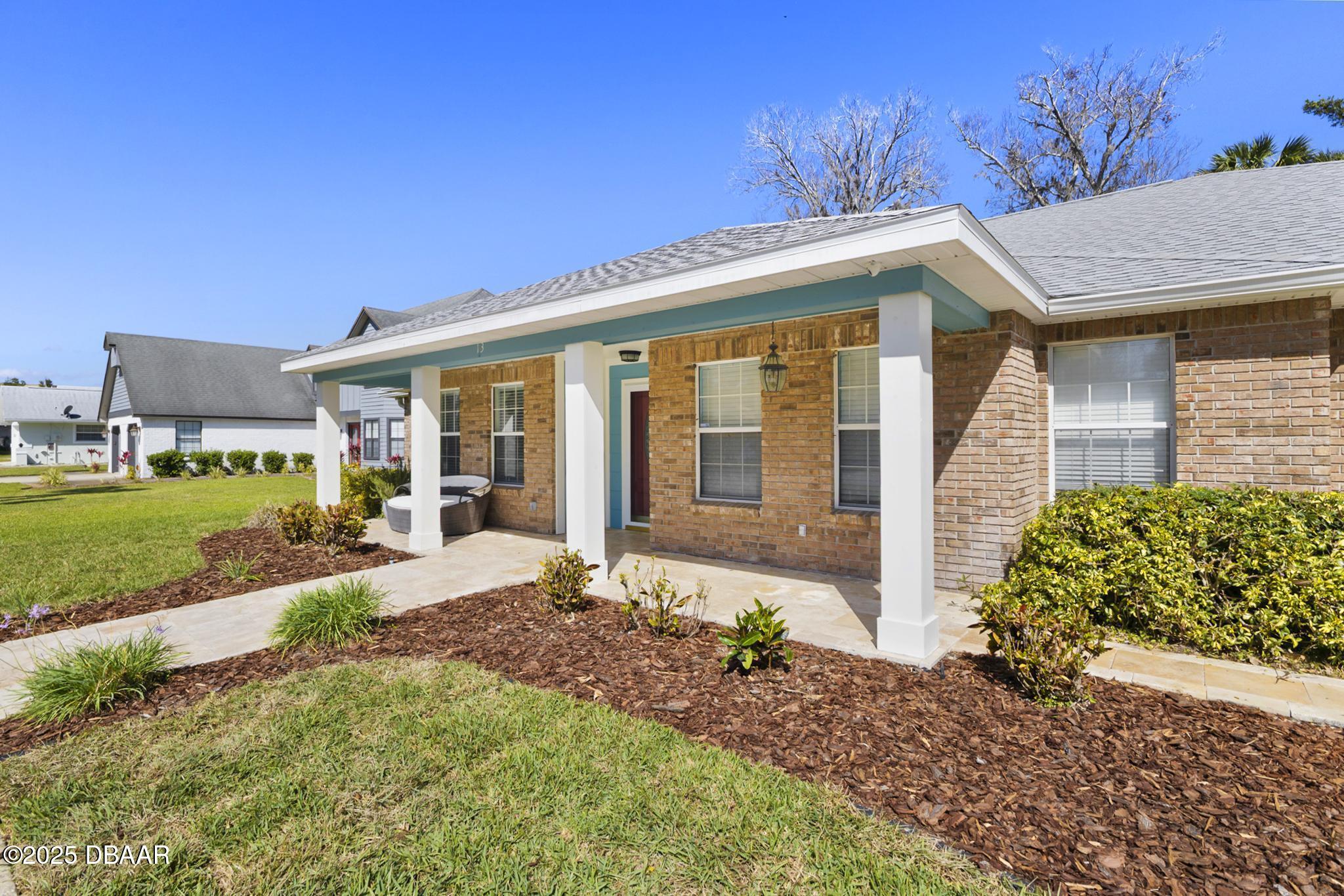 13 Fernery Trail Ormond Beach, FL 32174 - Photo 3 of 57 a front view of a house with a garden and plants