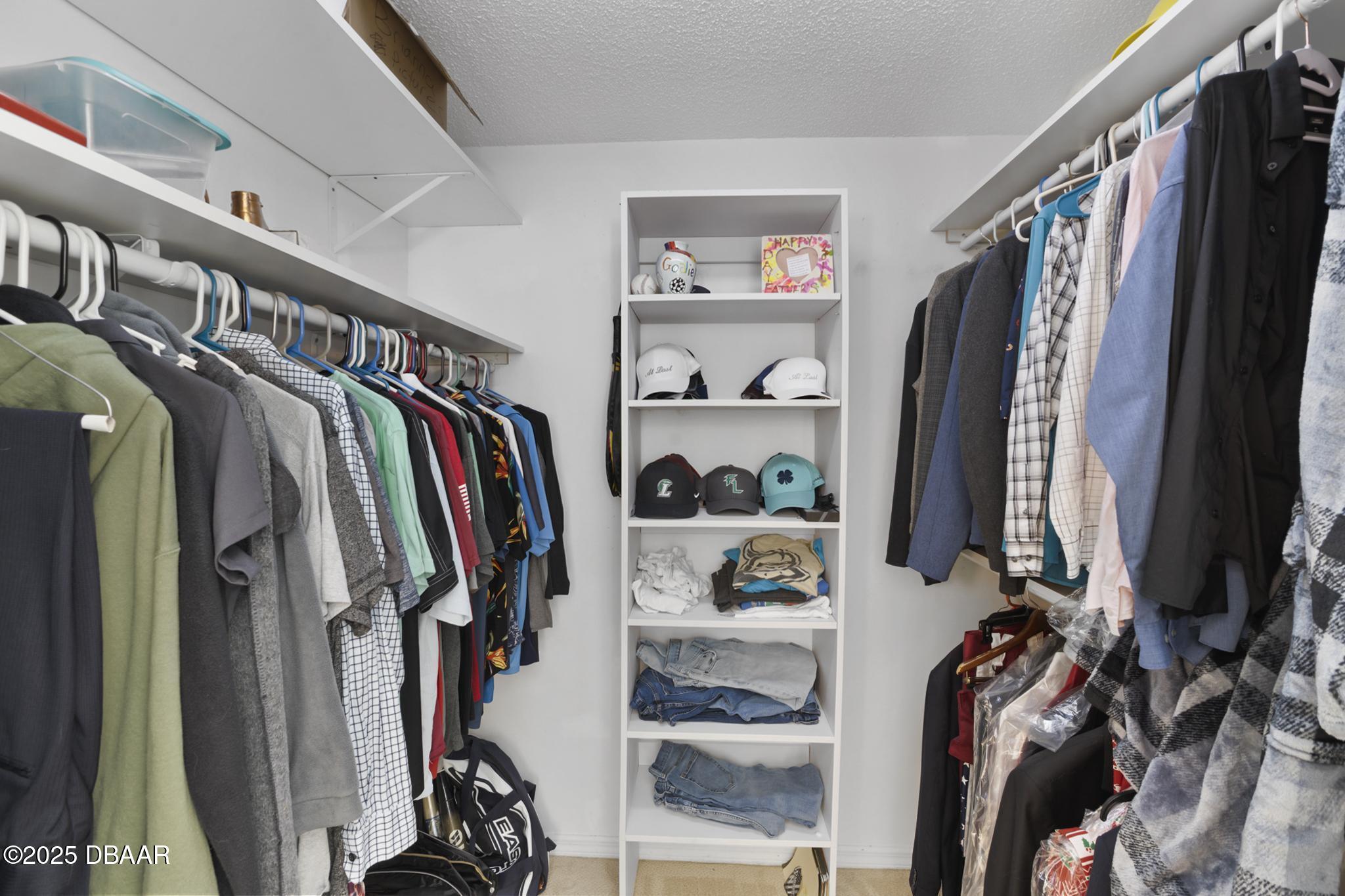 13 Fernery Trail Ormond Beach, FL 32174 - Photo 30 of 57 a view of walk in closet with clothes and shoes
