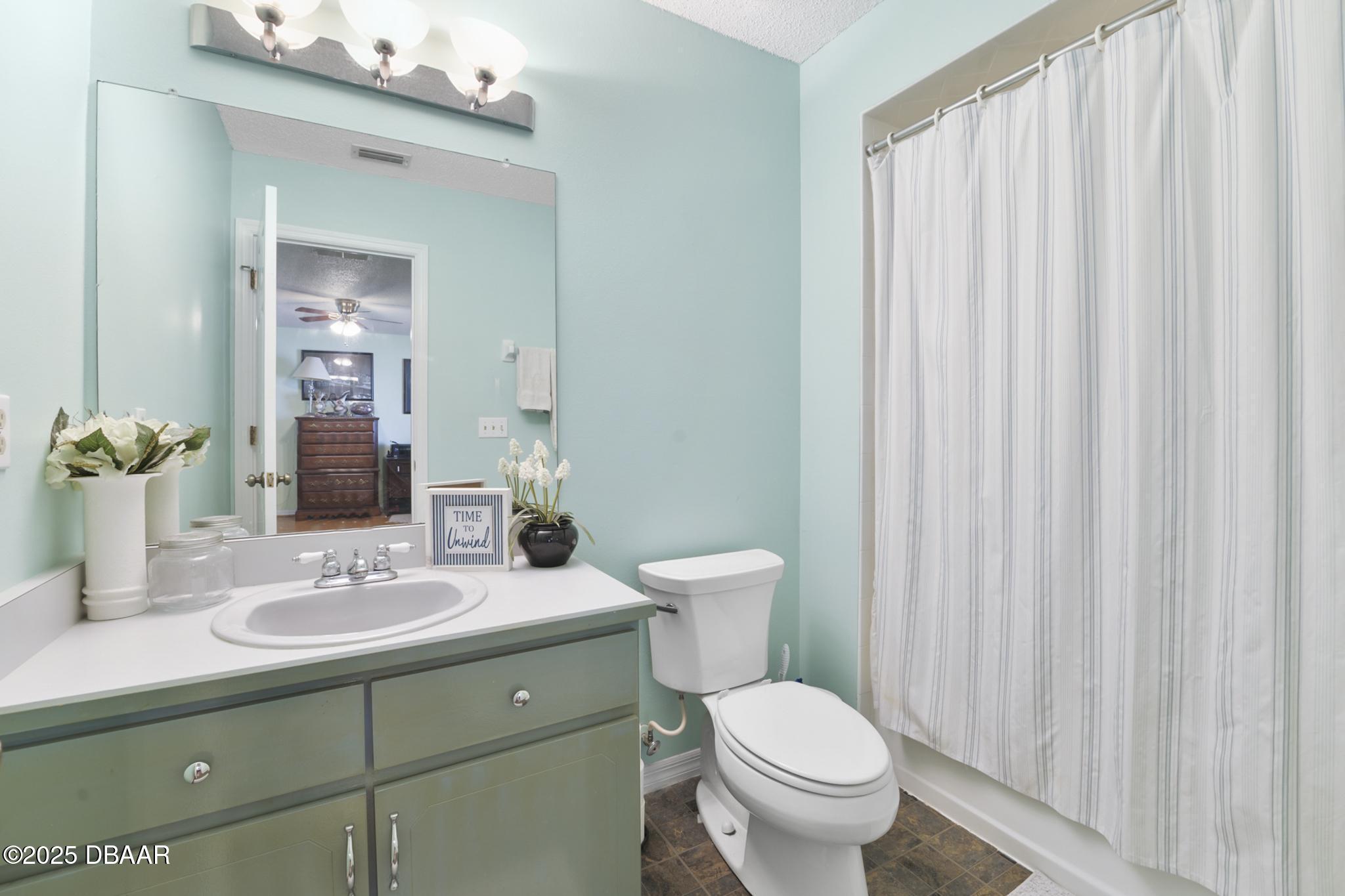 13 Fernery Trail Ormond Beach, FL 32174 - Photo 36 of 57 a bathroom with a toilet a sink and a mirror