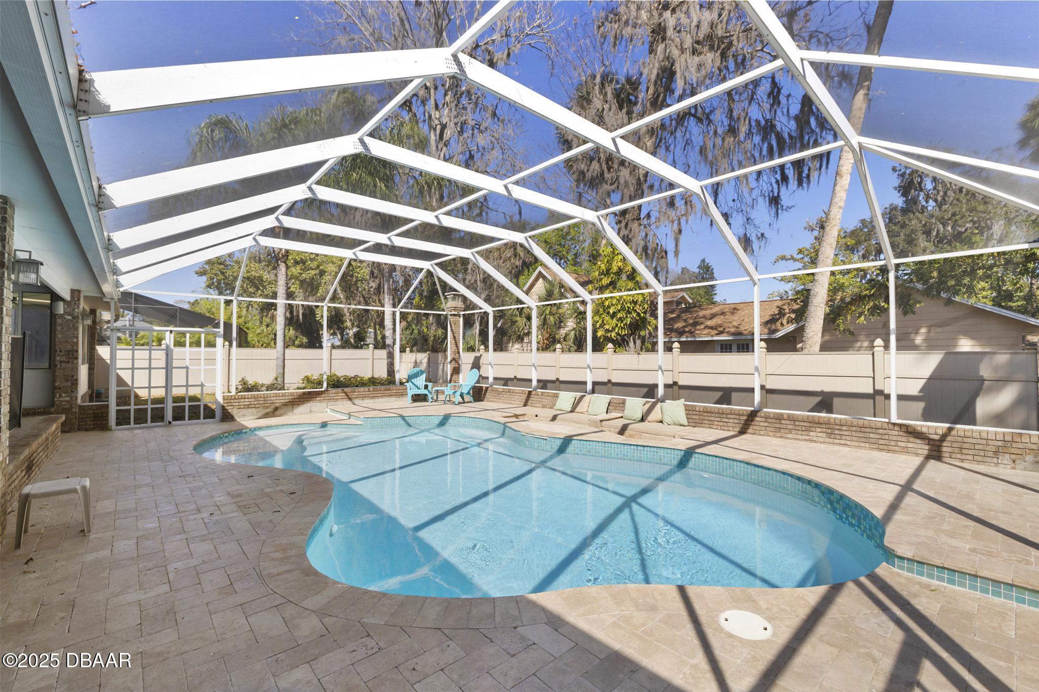 13 Fernery Trail Ormond Beach, FL 32174 - Photo 43 of 57 a view of a backyard with table and chairs