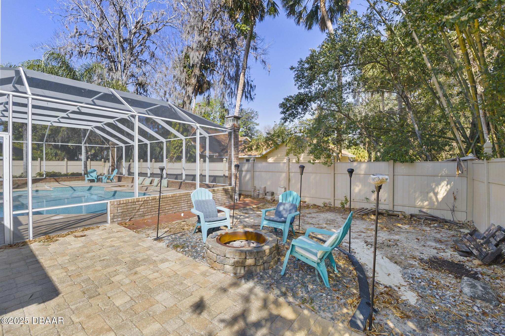 13 Fernery Trail Ormond Beach, FL 32174 - Photo 44 of 57 a backyard of a house with barbeque oven table and chairs