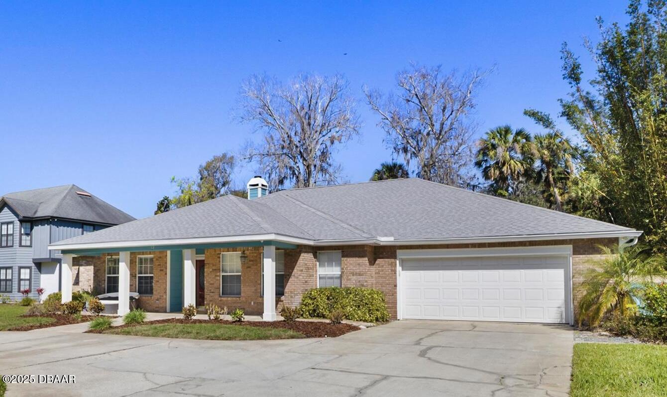 13 Fernery Trail Ormond Beach, FL 32174 - Photo 52 of 57 a front view of a house with garden