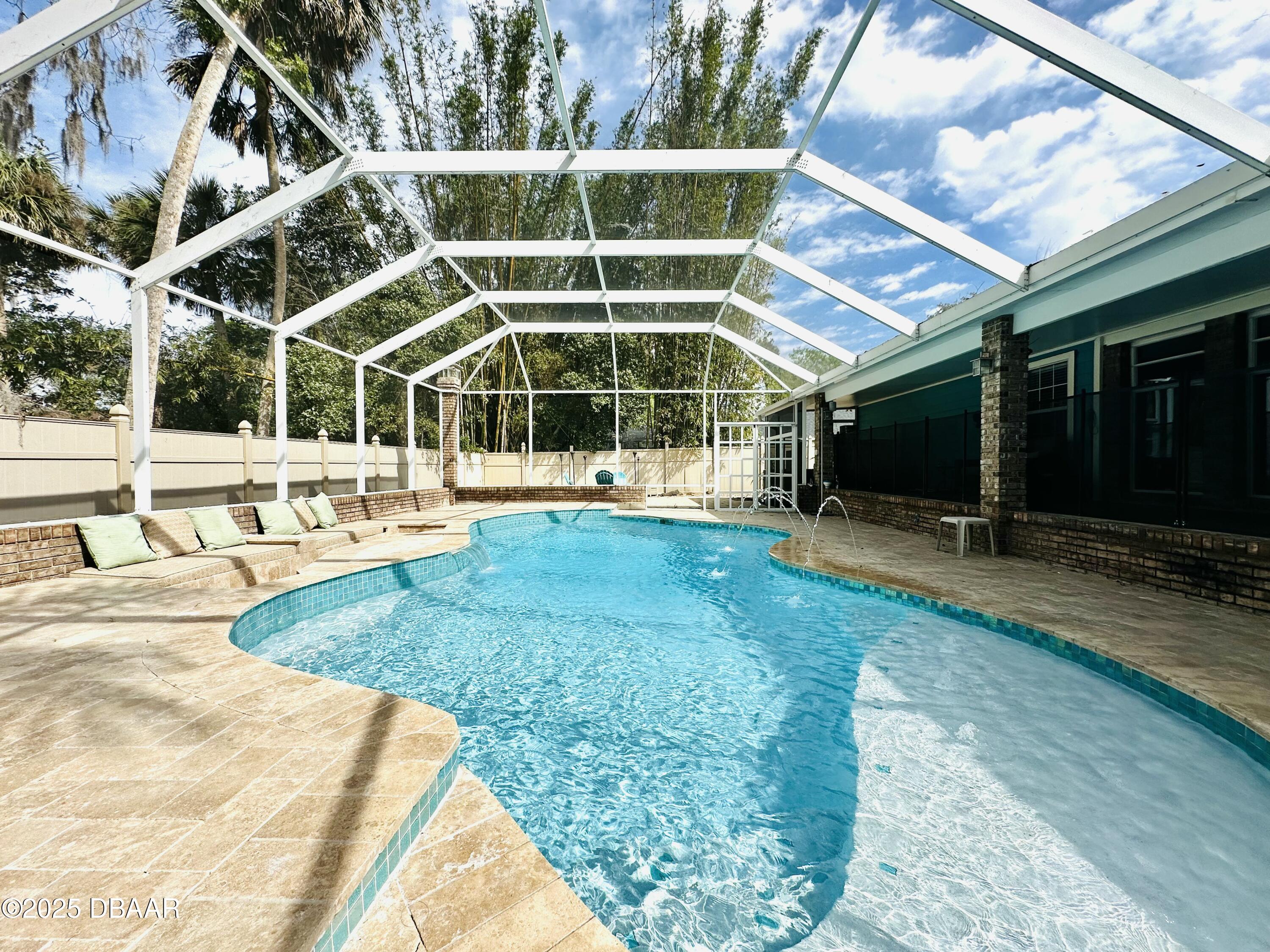 13 Fernery Trail Ormond Beach, FL 32174 - Photo 6 of 57 a view of a swimming pool with an outdoor seating