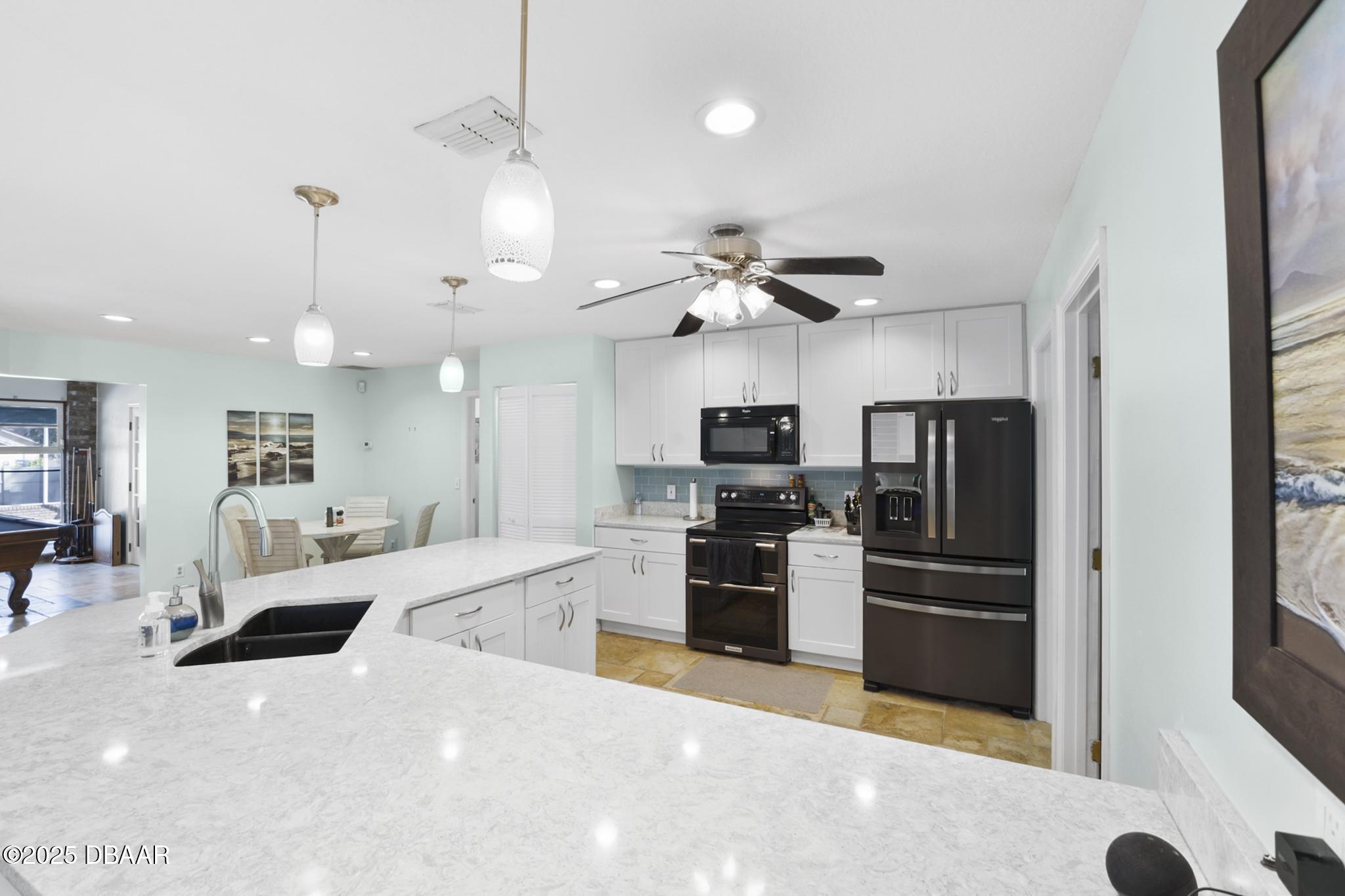 13 Fernery Trail Ormond Beach, FL 32174 - Photo 8 of 57 a large kitchen with a large counter top appliances and cabinets