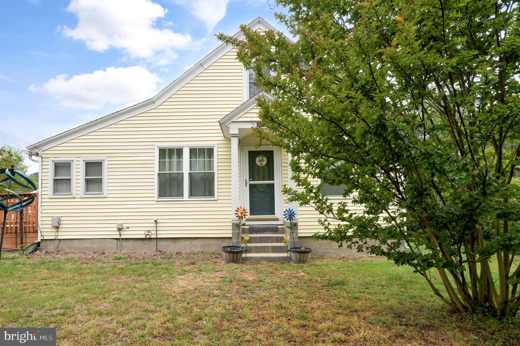 7278 Fleming Road New Church, VA 23415 - Photo 2 of 44 a front view of a house with a yard