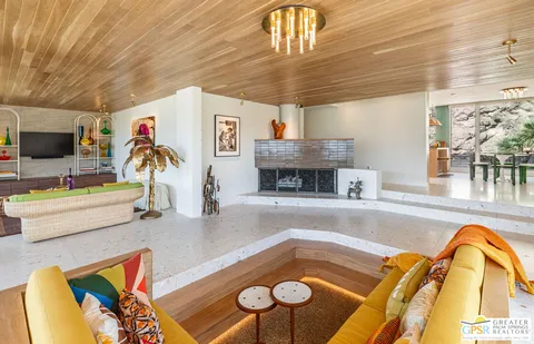 a view of a dining room with furniture and a large window
