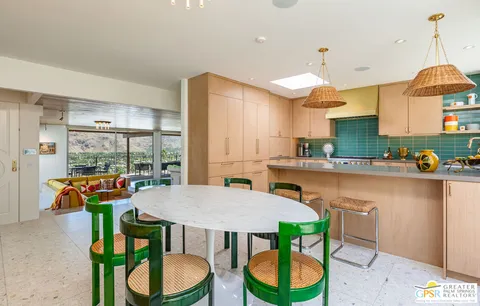 a view of a dining room with furniture and a large window