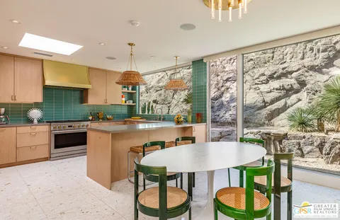 a view of a patio with table and chairs and potted plants