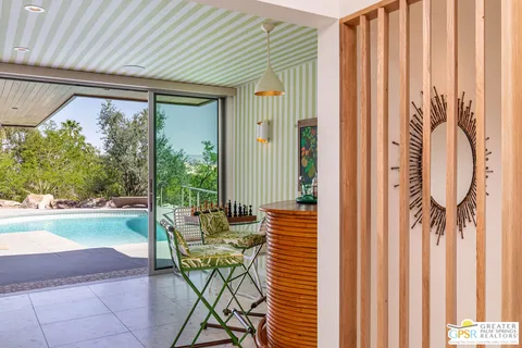 a view of a swimming pool with a table and chairs