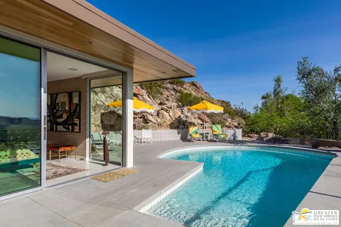a bedroom with a bed and glass window