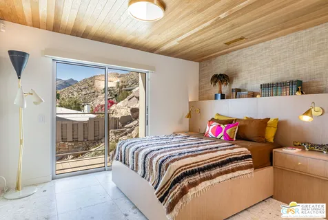 a bathroom with a granite countertop sink mirror and toilet