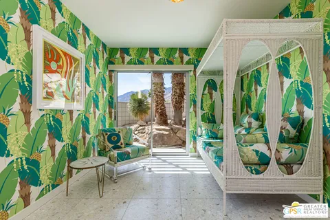 a view of a chairs and table in patio with a garden