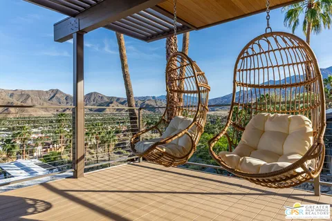 a front view of a house with a mountain in the background