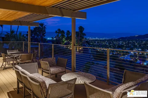 a view of a balcony with two chairs and a table