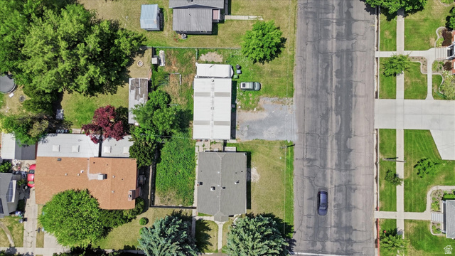 395 North 400 West Logan, UT 84321 - Photo 34 of 48 Aerial perspective showcasing a residential property with a brown-shingled roof and a spacious green yard