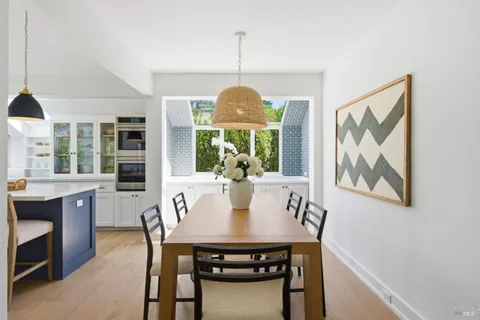 a kitchen with a stove a sink and a wooden cabinets