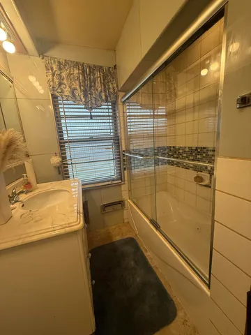 a bathroom with a sink toilet and mirror