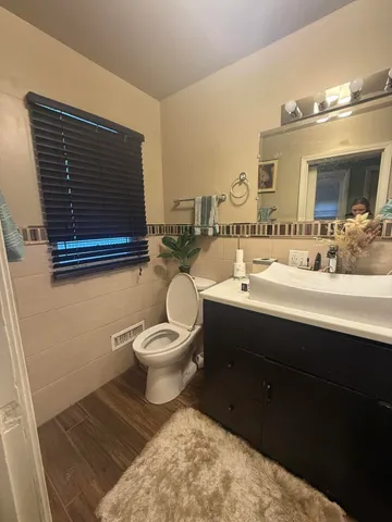 a bathroom with a granite countertop sink a mirror and shower