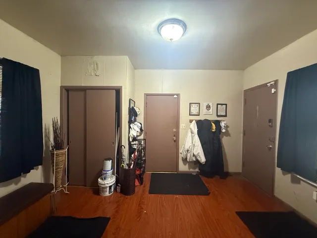 a view of a kitchen with refrigerator and workspace