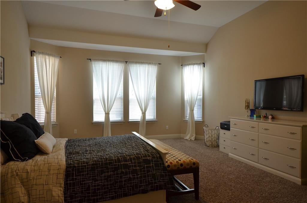 5629 Rio Chama Cove Austin, TX 78738 - Photo 13 of 34 A primary bedroom offering generous space, soft carpeting, and a gently angled vaulted ceiling.