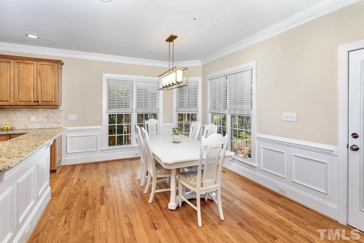 8333 Wheatstone Lane Raleigh, NC 27613 - Photo 11 of 34 a view of a dining room with furniture window and wooden floor