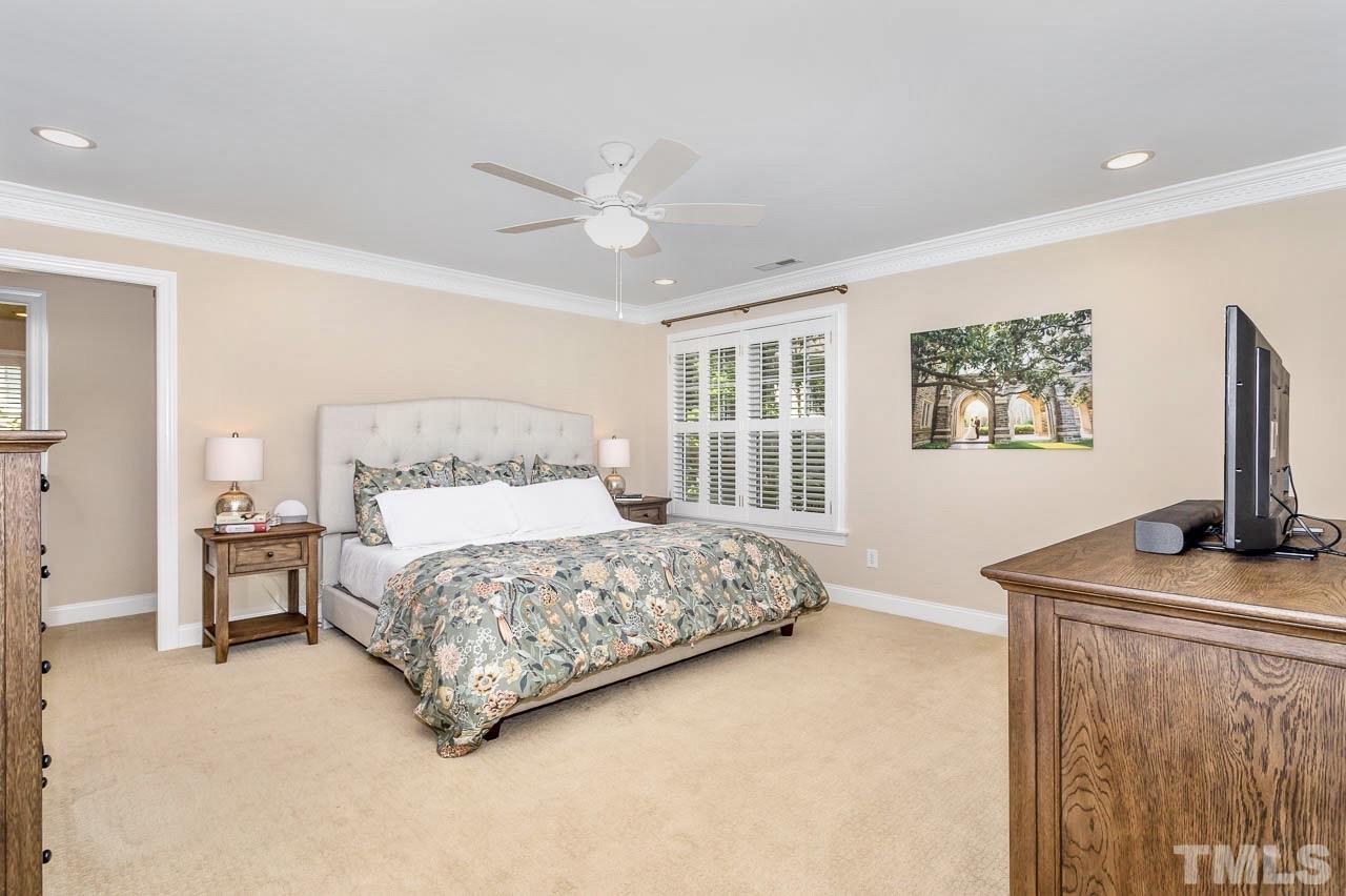 8333 Wheatstone Lane Raleigh, NC 27613 - Photo 14 of 34 a bedroom with a bed flat screen tv and window