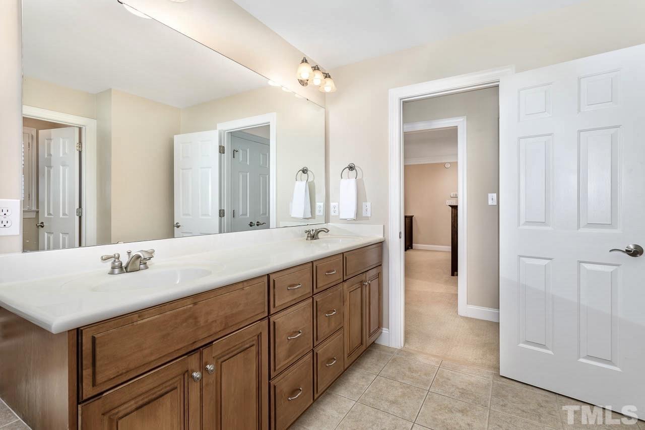 8333 Wheatstone Lane Raleigh, NC 27613 - Photo 17 of 34 a spacious bathroom with a double vanity sink mirror and double