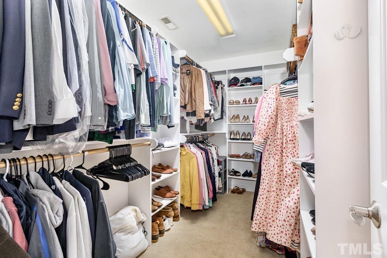 8333 Wheatstone Lane Raleigh, NC 27613 - Photo 18 of 34 a view of walk in closet with clothes and shoes