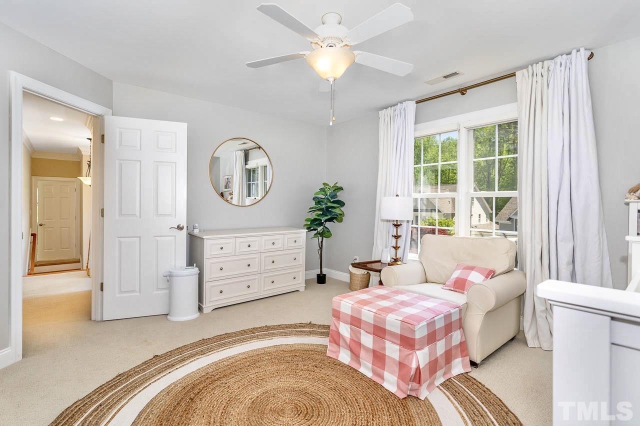 8333 Wheatstone Lane Raleigh, NC 27613 - Photo 20 of 34 a bedroom with a bed and a chandelier