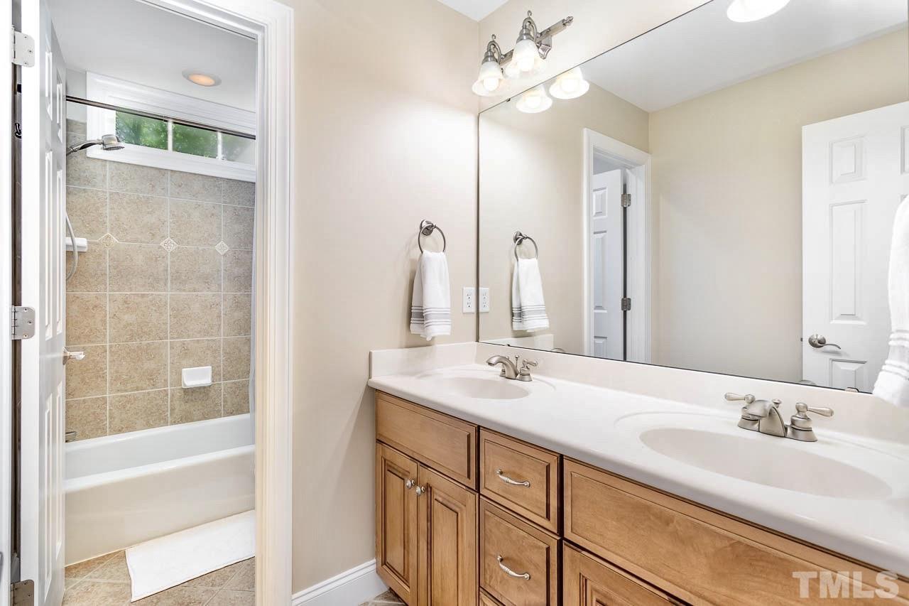 8333 Wheatstone Lane Raleigh, NC 27613 - Photo 21 of 34 a bathroom with a double vanity sink mirror and bathtub